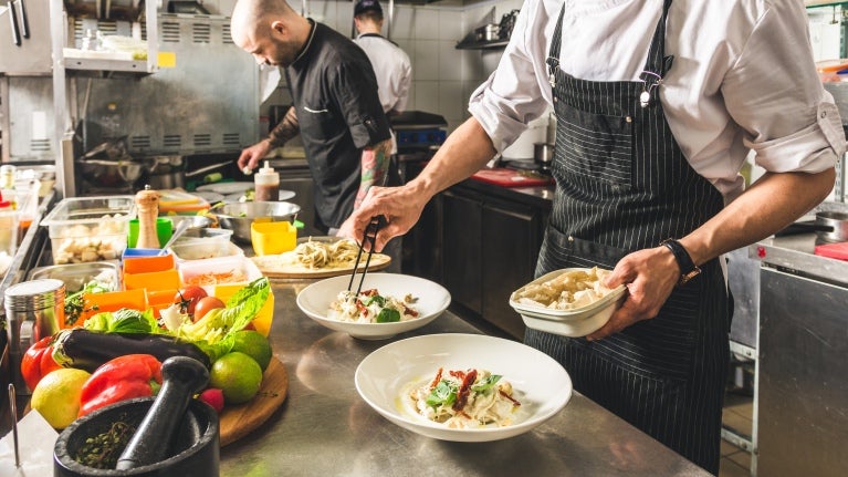 Chefs working in a dark kitchen