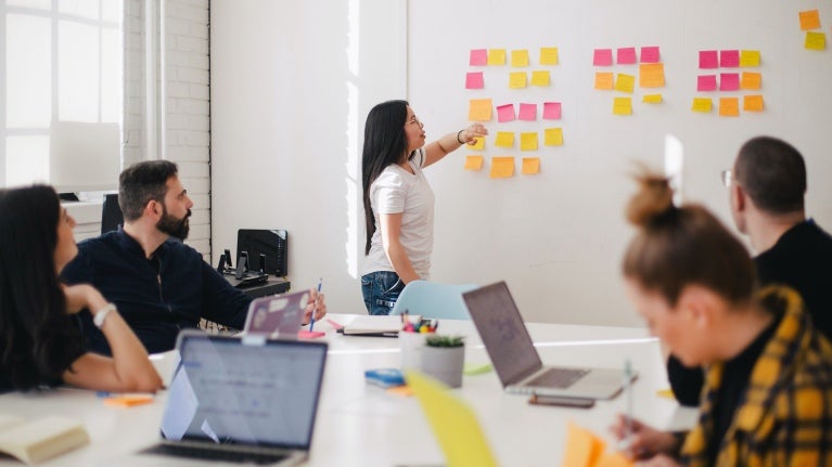 Group of workers brainstorming with sticky notes