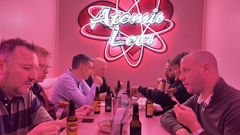 crowd of people standing around tables and food exploration tour