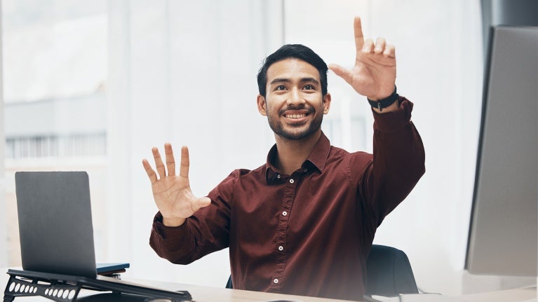 manager sitting at a desk explaining his vision