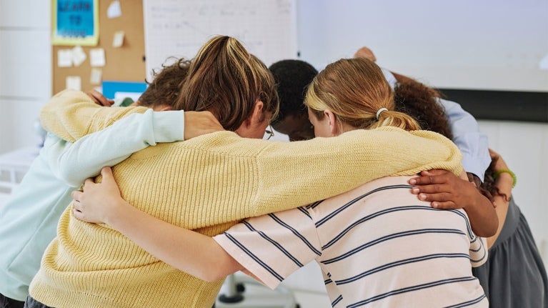 employees in a huddle together