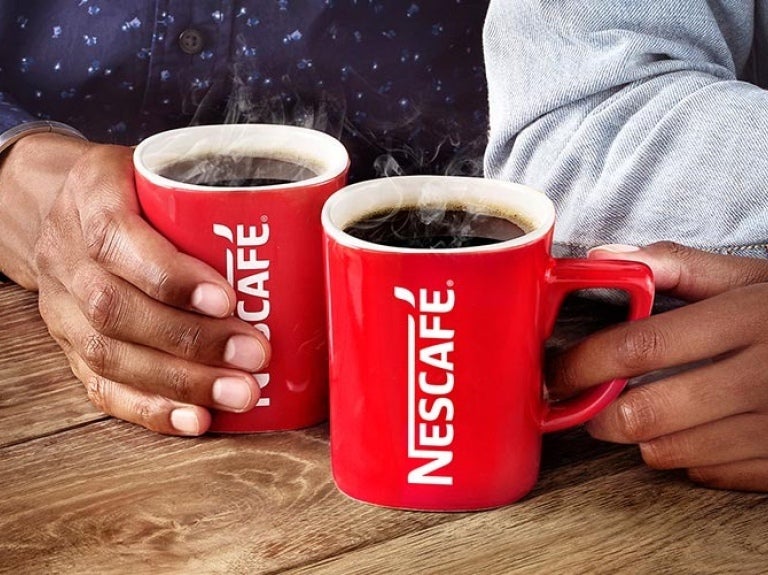 two people enjoying a cup of Nescafé coffee at their workplace