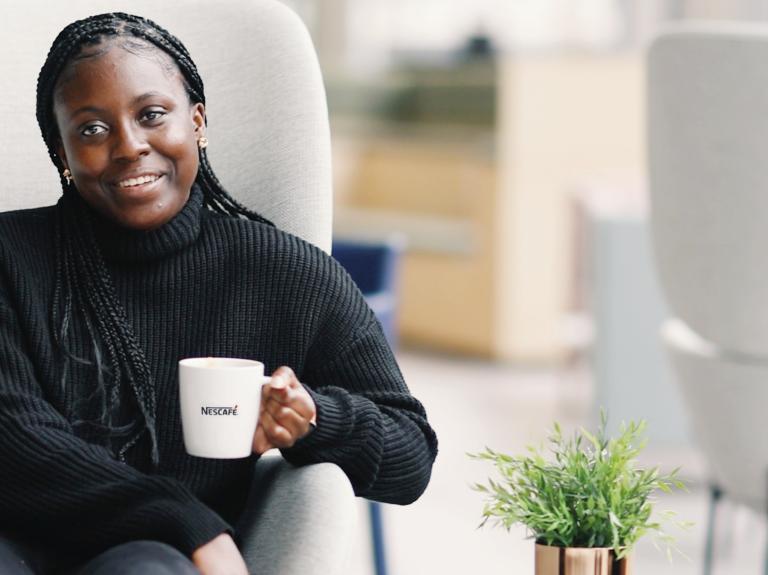 woman sat on chair with coffee