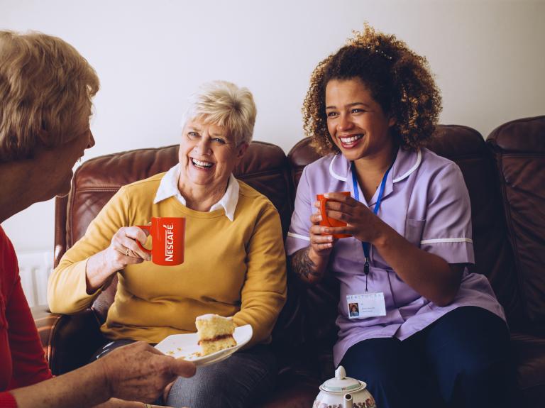 nurse drinking coffee with patients