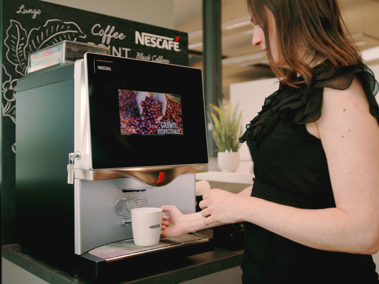 woman making coffee with nescafe machine