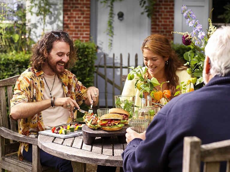 3 people dining in  a pub garden