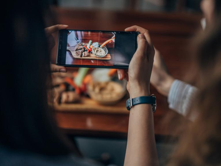 Person taking photo of food