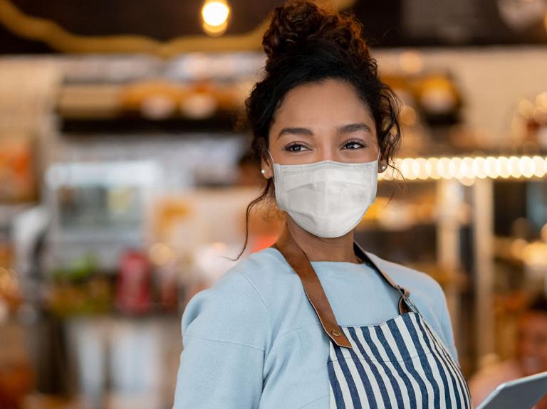 Woman wearing a mask in restaurant