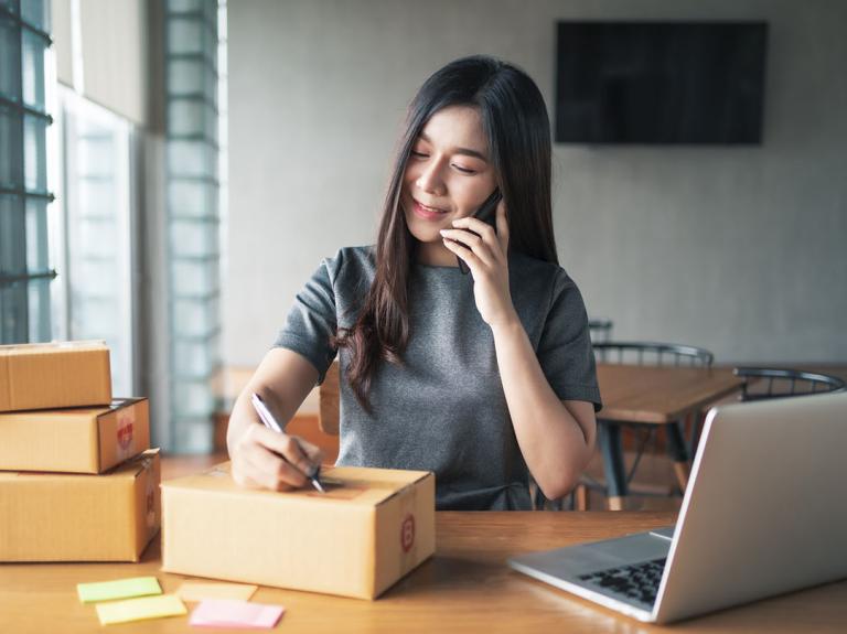 Woman signing a parcel