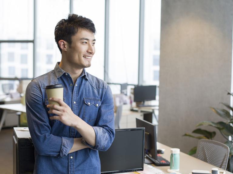 A man holding a coffee cup