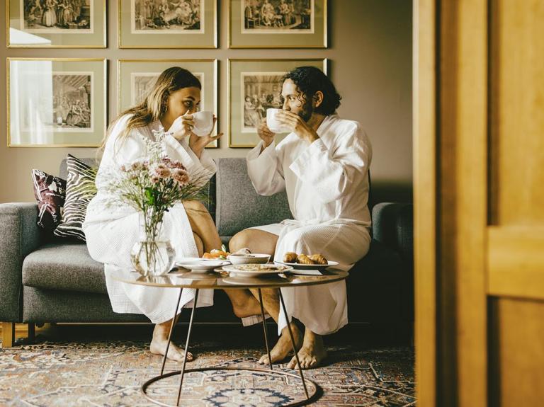 a couple drinking coffee in a hotel