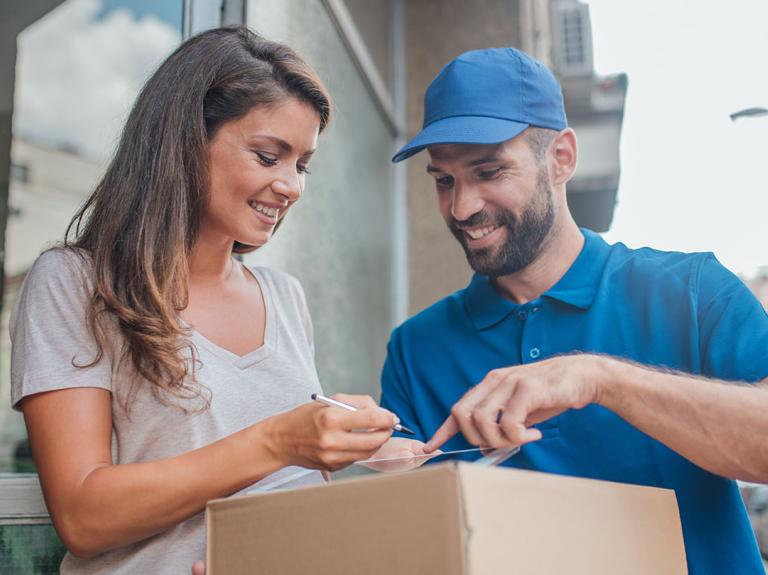 A woman signing for a parcel