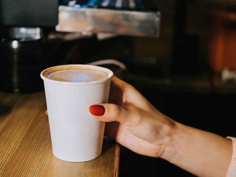 Person holding coffee cup