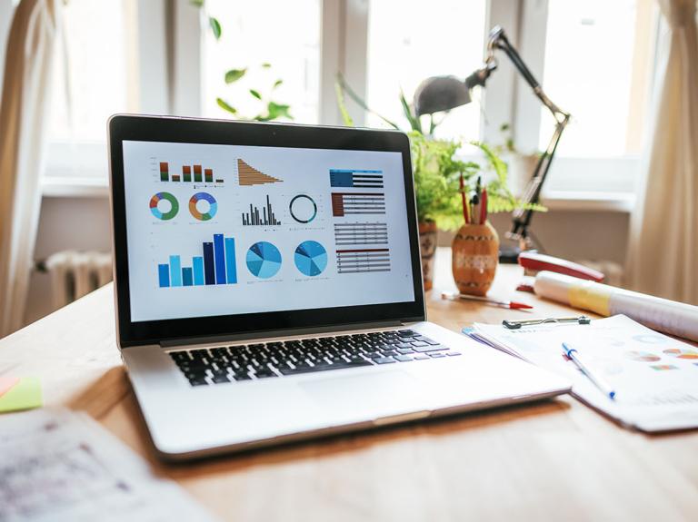 A laptop showing graphs