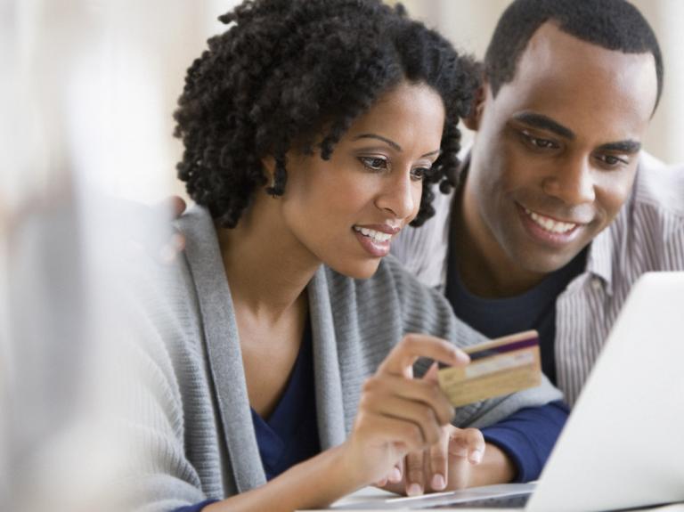 Two people looking at their laptop