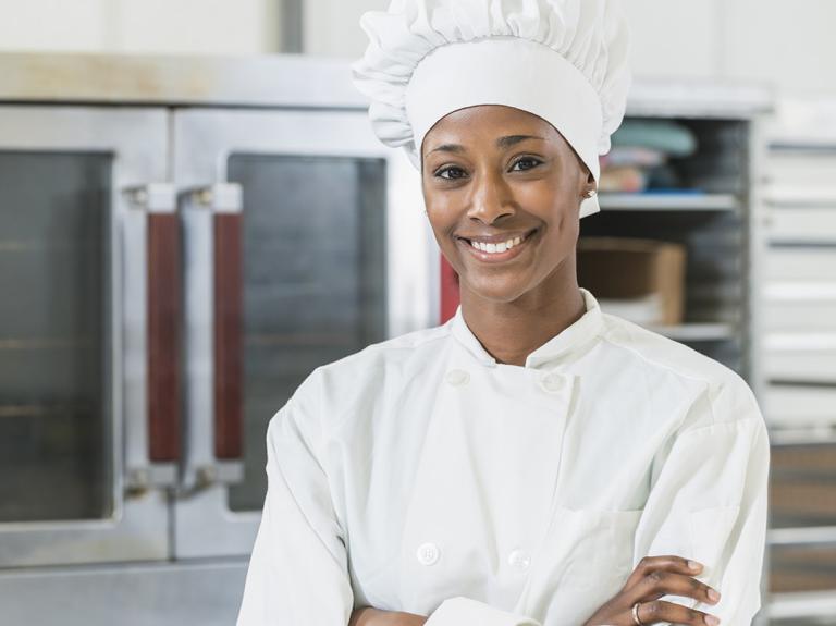 A chef smiling in a kitchen