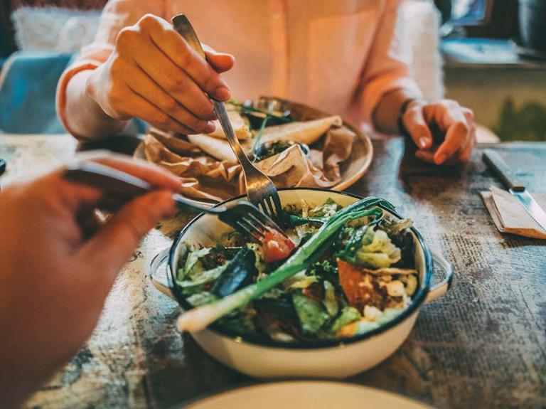 Two people enjoying a plant based meal