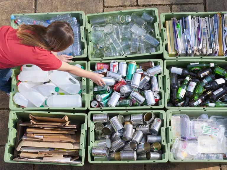 A person sorting through recycling
