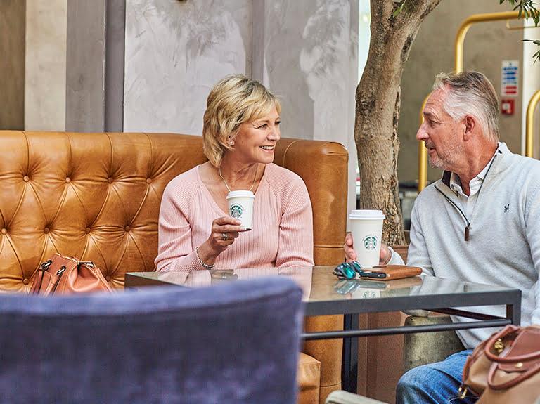 two hotel guests enjoying a starbucks