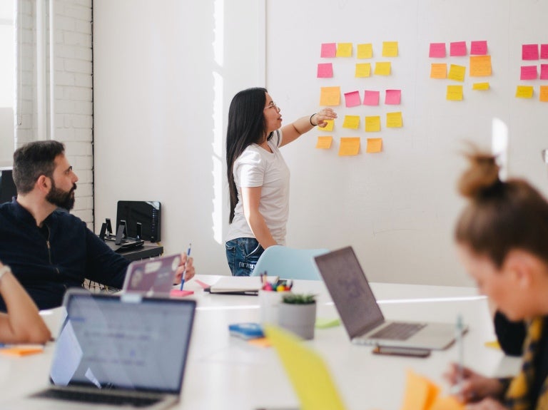 Group of workers brainstorming with sticky notes