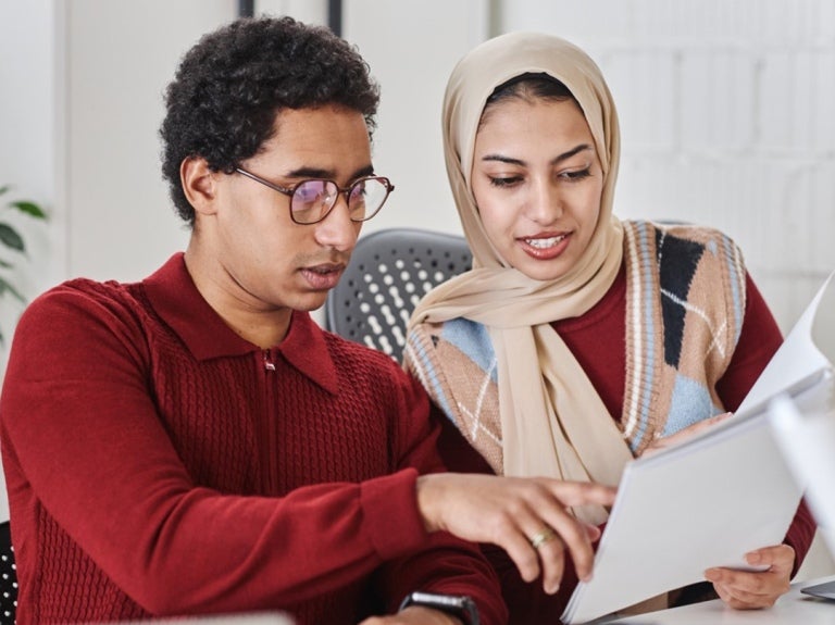 manager and employee looking at folder