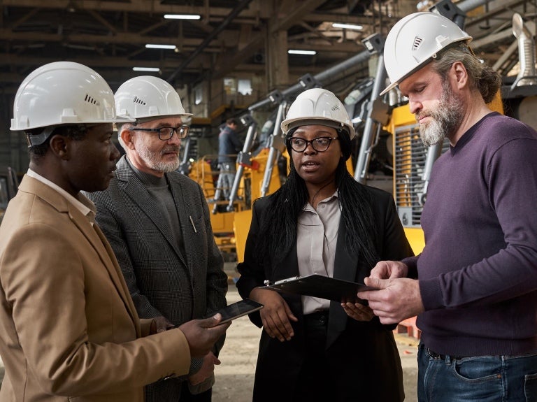 group of colleagues meeting on the factory floor