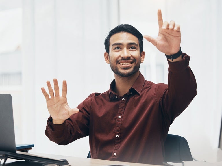 manager sitting at a desk explaining his vision