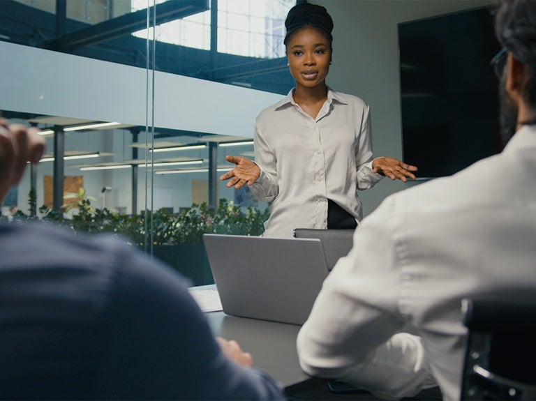 manager standing up and coaching employees