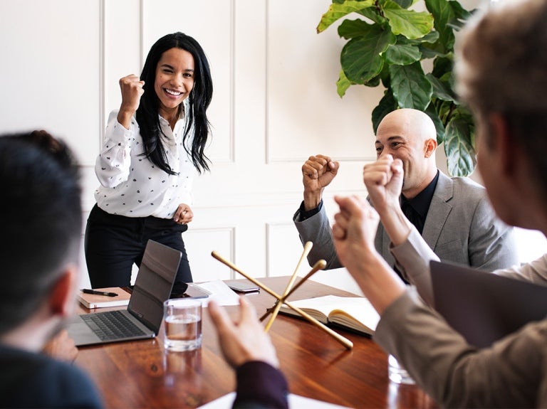 employees and manager around a meeting table