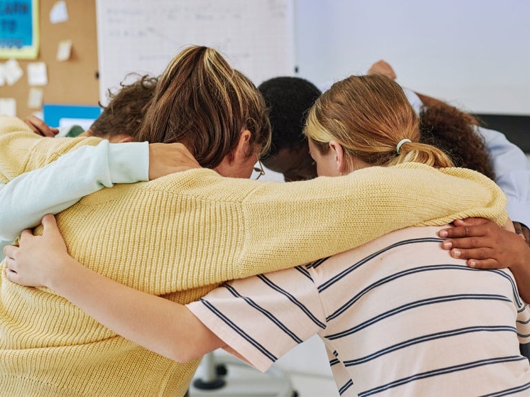 employees in a huddle together