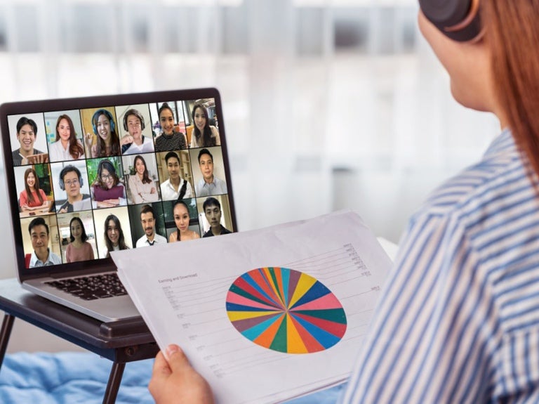 woman leading a virtual meeting on her laptop from home