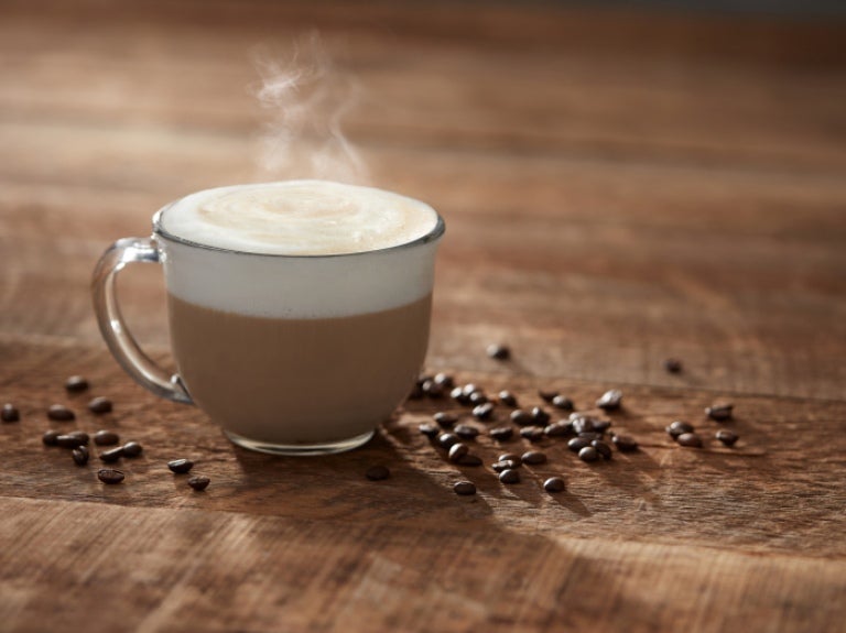 Hot coffee on a table with steam