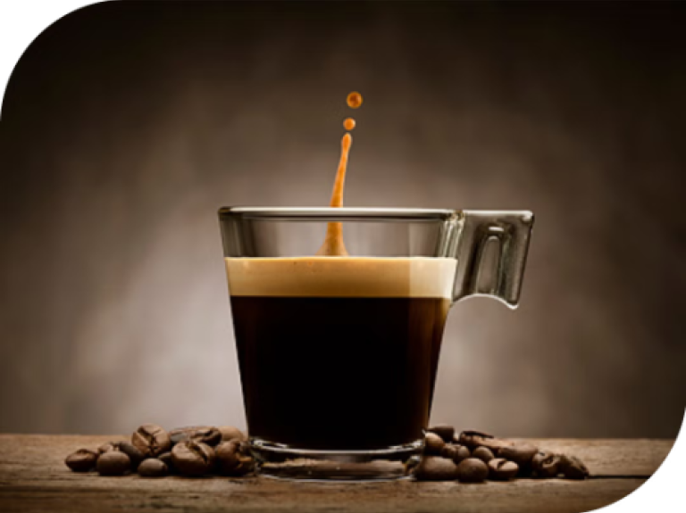 espresso coffee cup with coffee being poured in