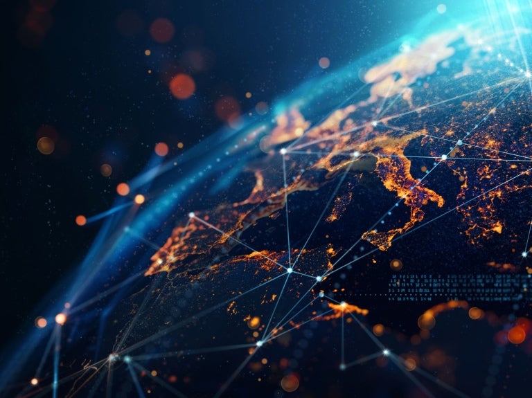 A digital globe illustration featuring illuminated continents connected by glowing lines and abstract data visuals against