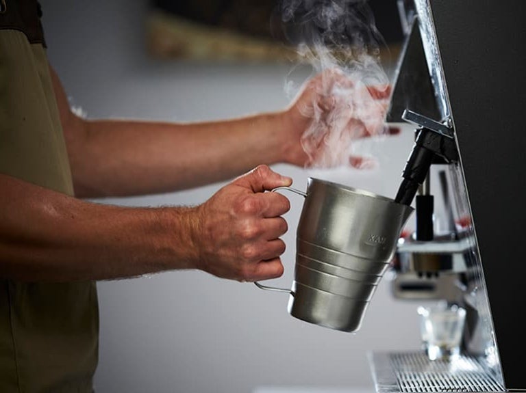 Barista steaming milk