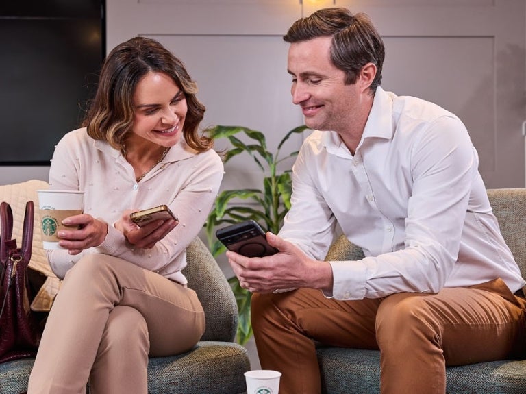 two guests enjoying coffee in hotel lobby