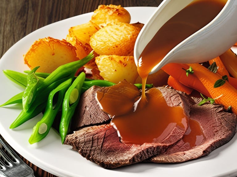 Gravy poured over roast dinner