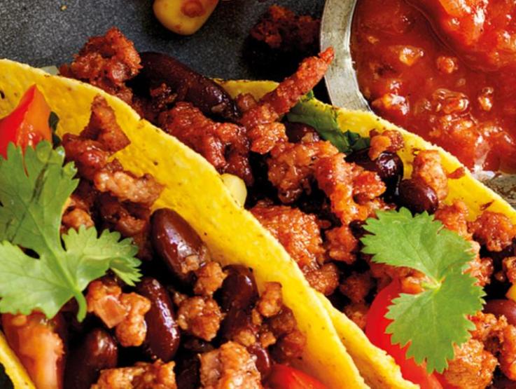 tacos with sauce on table