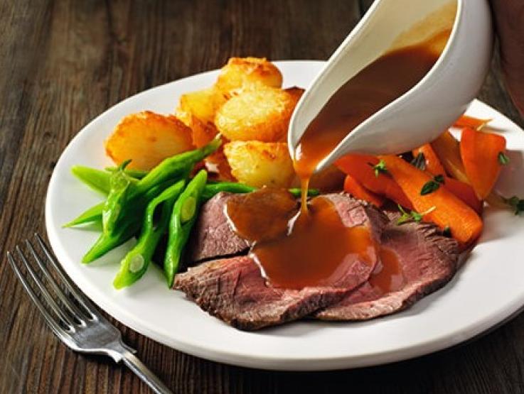 Gravy poured over roast dinner