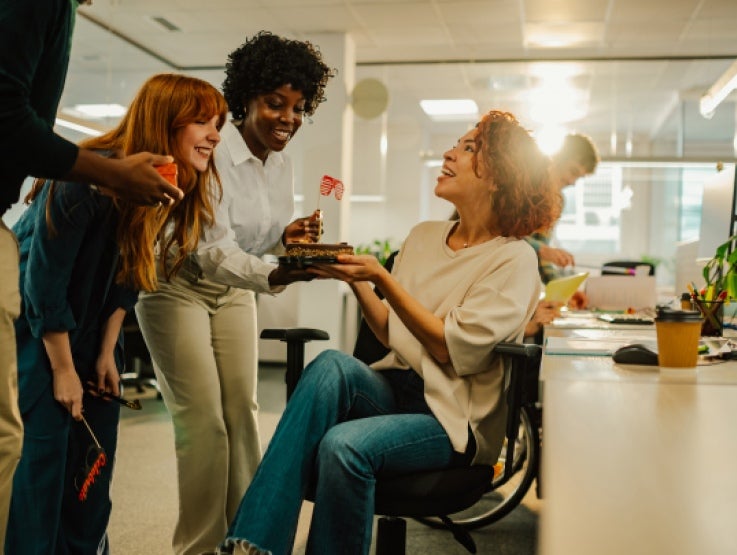 Employees socialising whilst drinking coffee, in the workplace