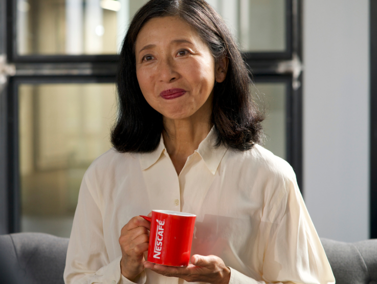 woman drinking nescafe coffee