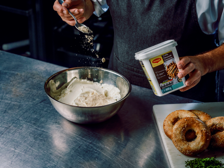 maggi truffle powder being sprinkled onto cream cheese