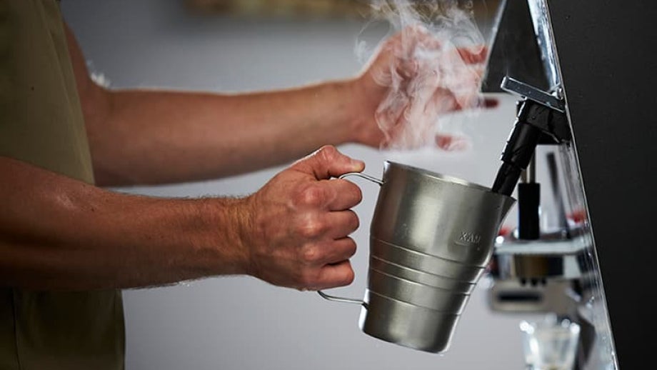 Barista steaming milk