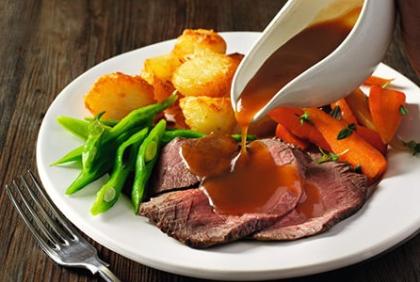 Gravy poured over roast dinner