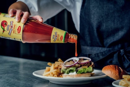maggi indian sauce being poured on burger