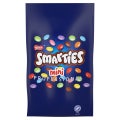 Nestlé Smarties Mini Professional chocolate candy in a blue bag with colorful candy pieces scattered on the front.