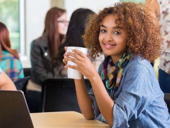 student drinking starbucks on campus