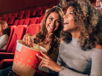 Two women laughing in the cinema