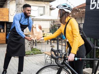 Man giving woman her order