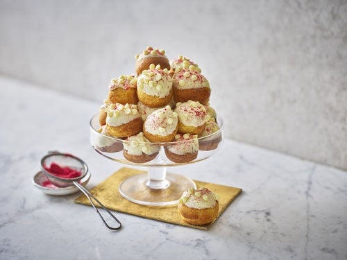 MILKYBAR White Chocolate and Raspberry Jam Profiterole Tower on a glass cake stand